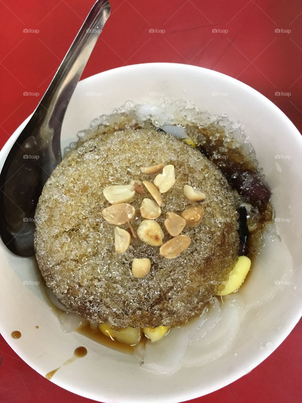 Various grains in syrup and sticky boiled dough on top with fined ice 