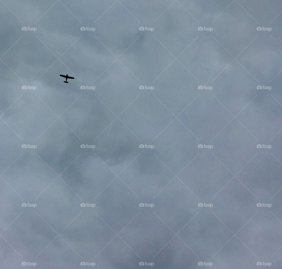 Plane in a cloudy gray sky