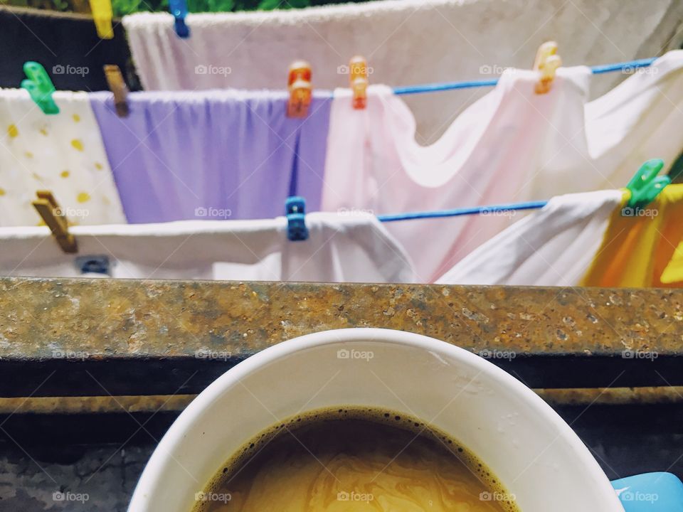 Having a coffee after doing the laundry. 