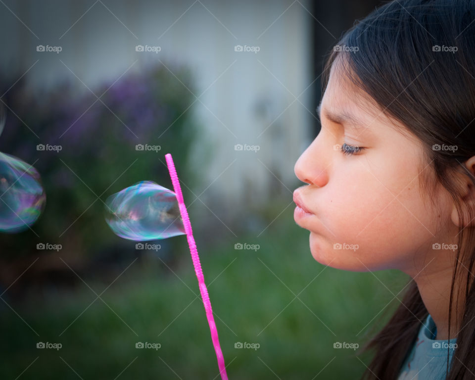 Bubbles. Child blowing bubbles