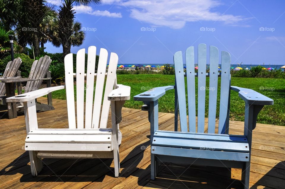 Two beach chairs at the beach. 