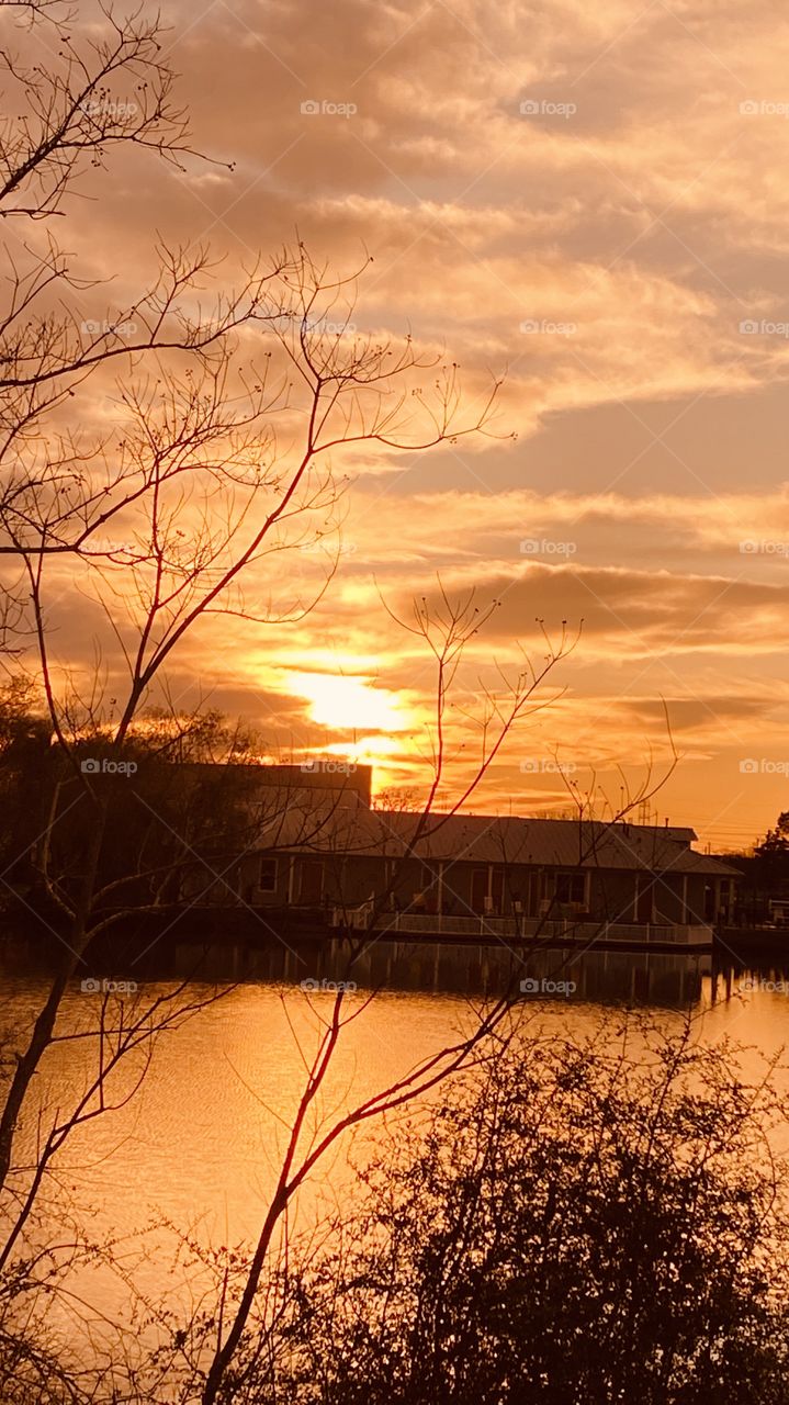Due to a Cold Airmass Front and the clouds parted late at sunset. As the sun sets deeper into the Horizon Colors get deep and more colors are spread across the sky.