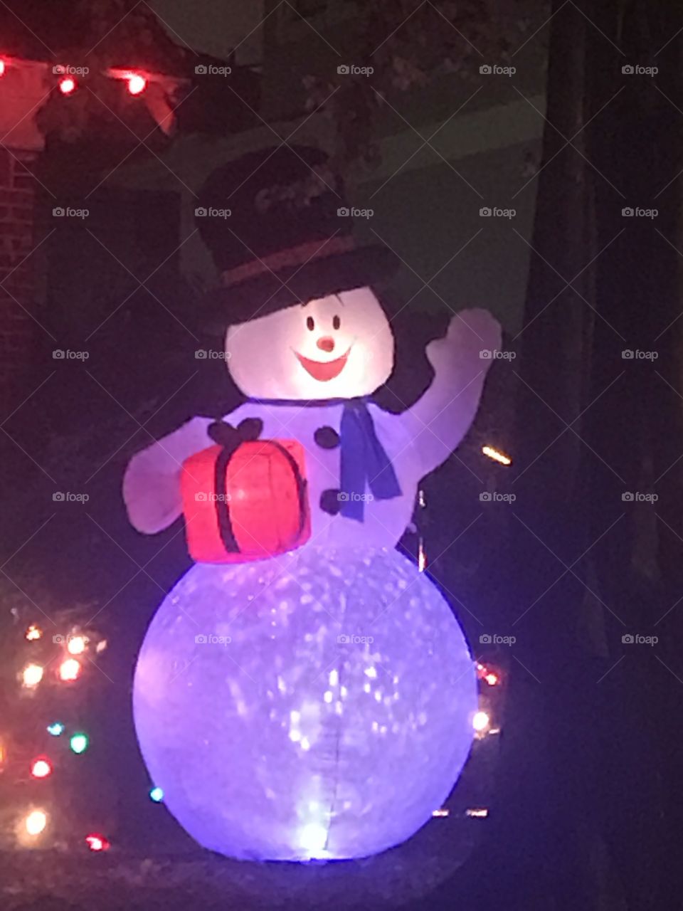Snowman holding a present 