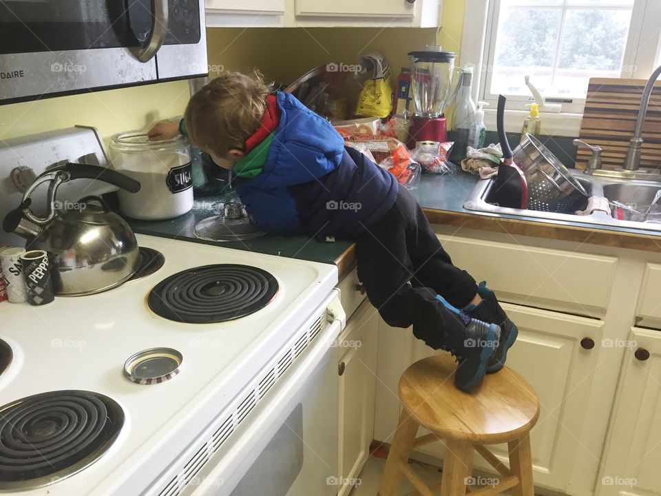 My two year old son helping himself to a spoon full of sugar. 