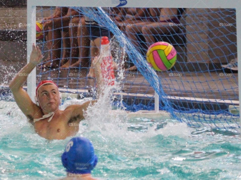 Waterpolo goalie in action save, in motion 