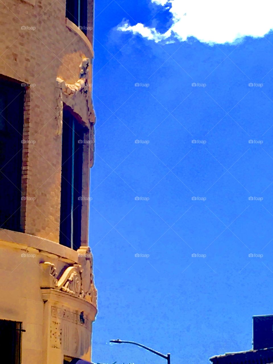 The round shaped building on Fulton Street, Brooklyn, New York with ornamented windows against a clear blue sky on an early afternoon in the summer of 2020. Hypnotic Productions
