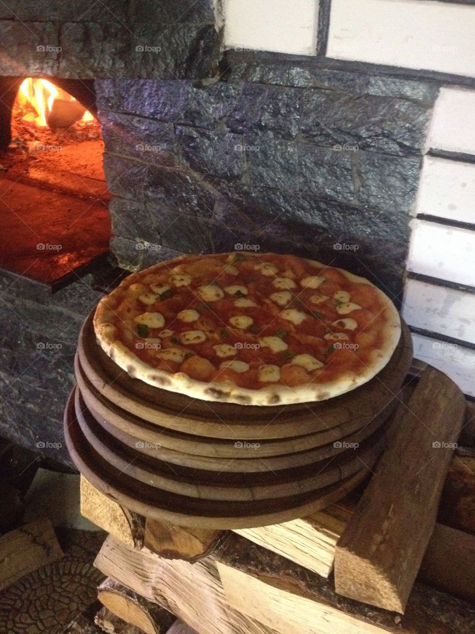 Freshly baked pizza margarita on a wooden tablet