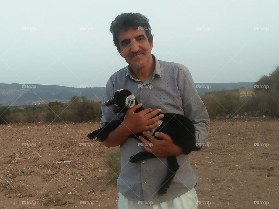 I m holding a baby goat