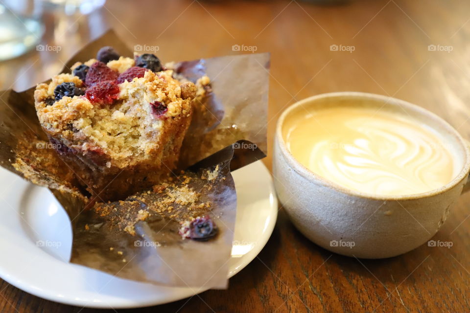 Muffin and coffee on a tabletop 