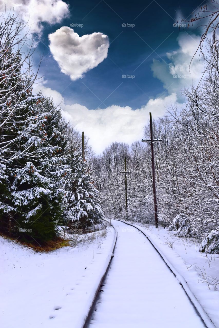 Beautiful views on a snowy Indiana day on the railroad tracks with a cool sky and a heart cloud in the sky. 