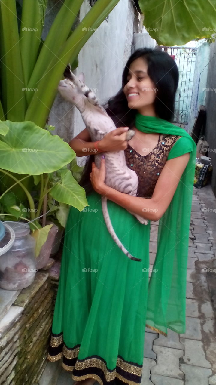 Indian girl holding cat