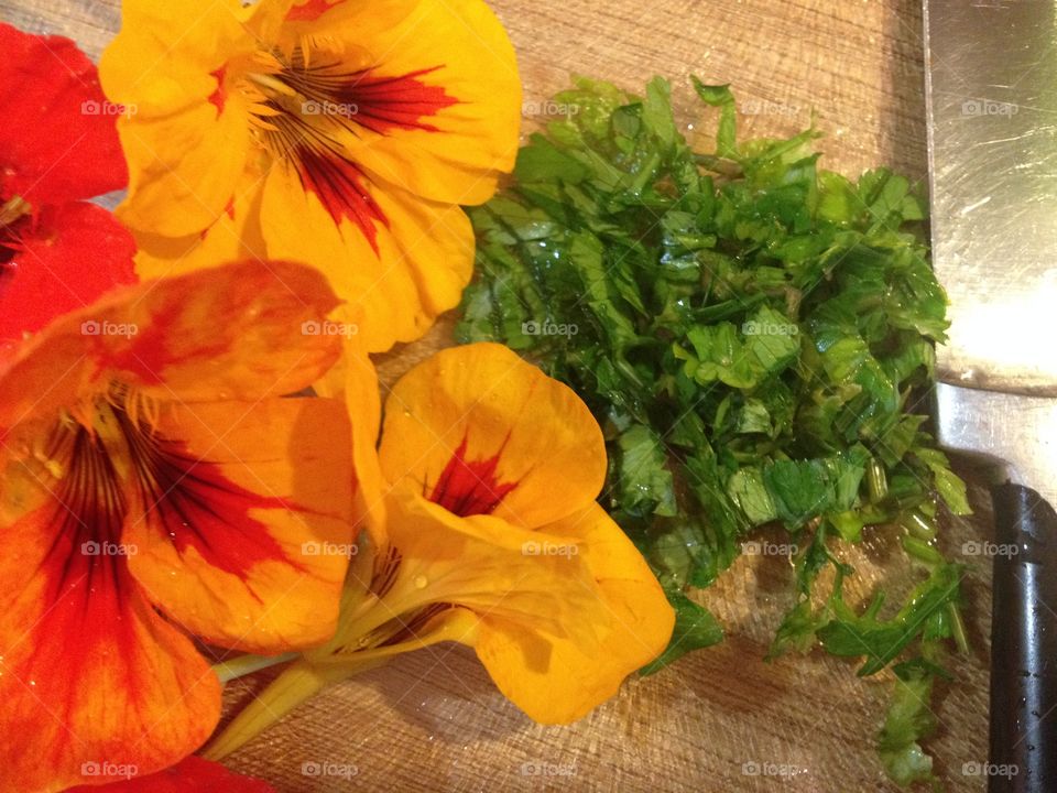 Nasturtiums and parsley on chopping board 