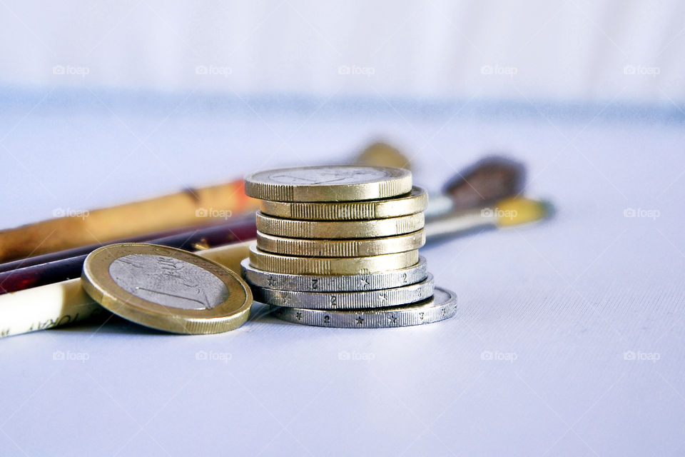 Euro coins with paint brushes