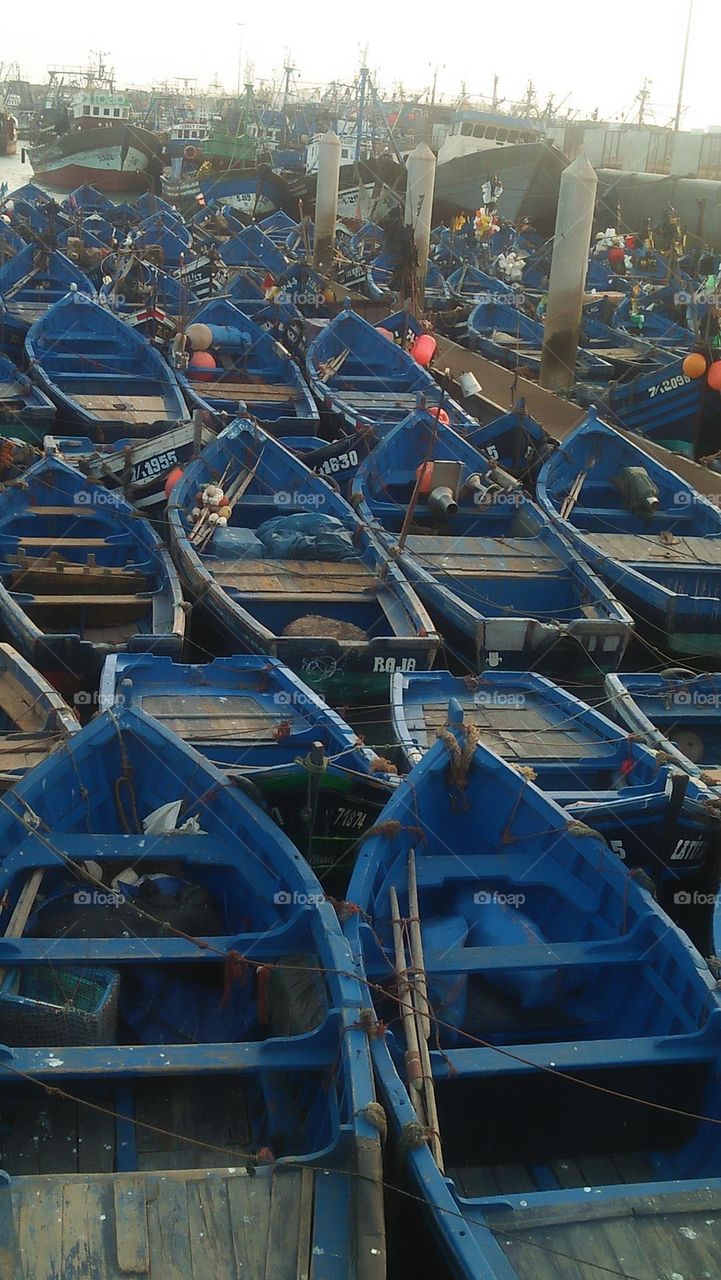 blue boats in the port.