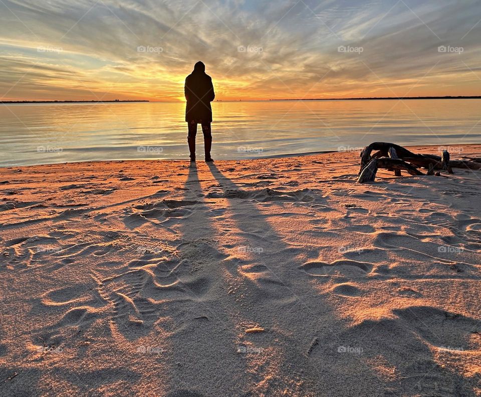 
Footprints in the sand - The sun begins to dip below the horizon, As if bidding the world a fond farewell. Its rays stretching out like a last embrace, Before it retreats into its slumbering place