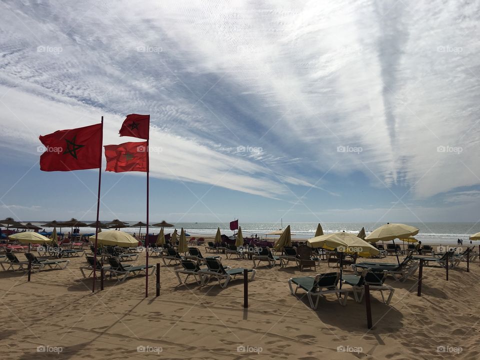 Moroccan beach with beach chairs and flags