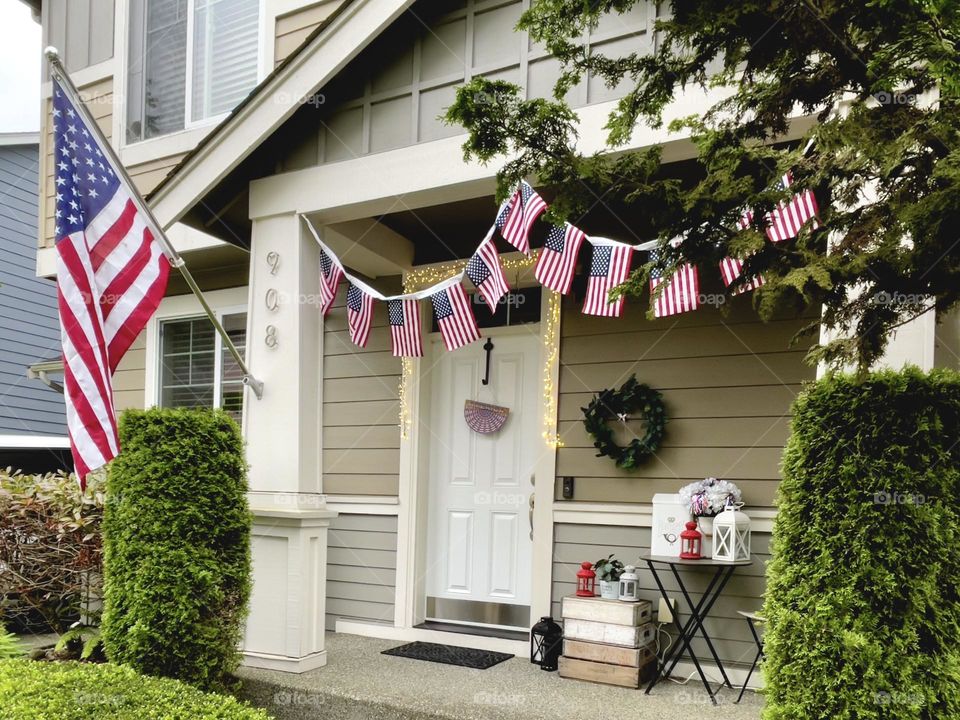Porch of American house decorated with flags for Independence Day 