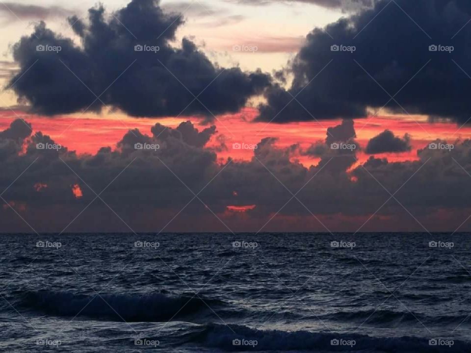 Fiery sunrise sky on the beach