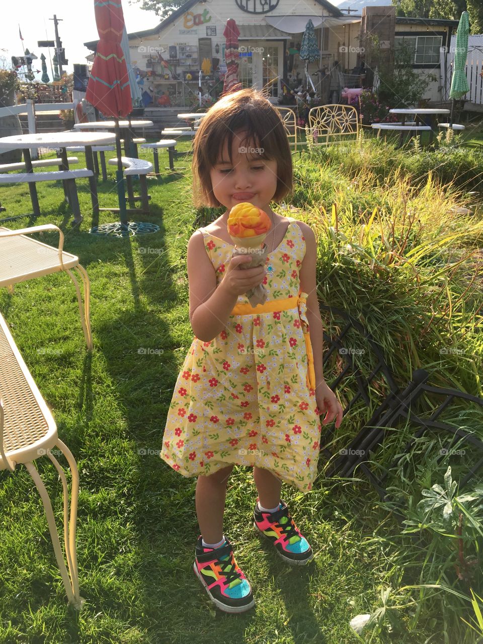 Cute girl holding tasty ice cream