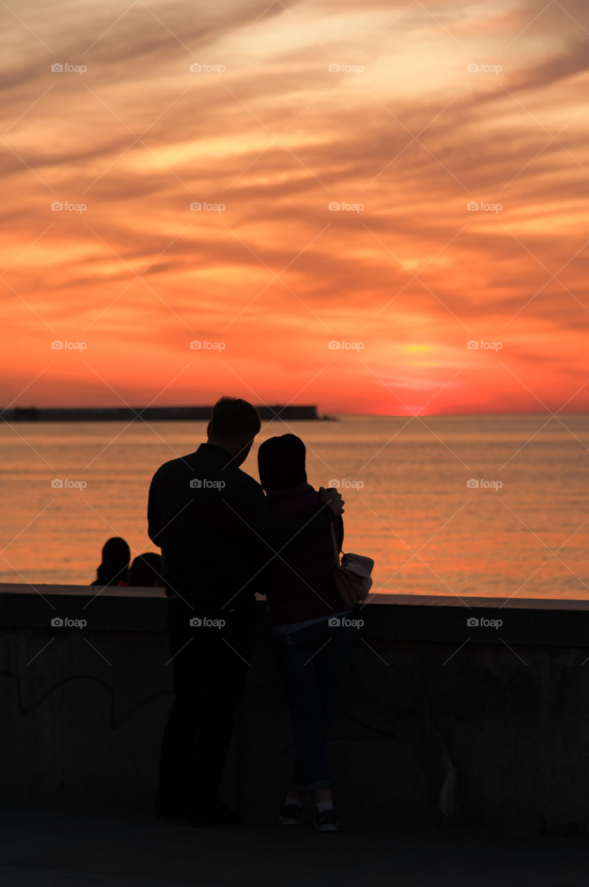 boy and girl admire the sunset