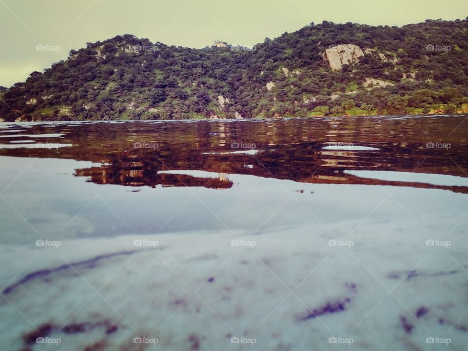 That is a picture of jaisamand lake situated in India that is the 2nd largest freshwater lake in Asia. That is a man made Lake that is built in 1685AD.