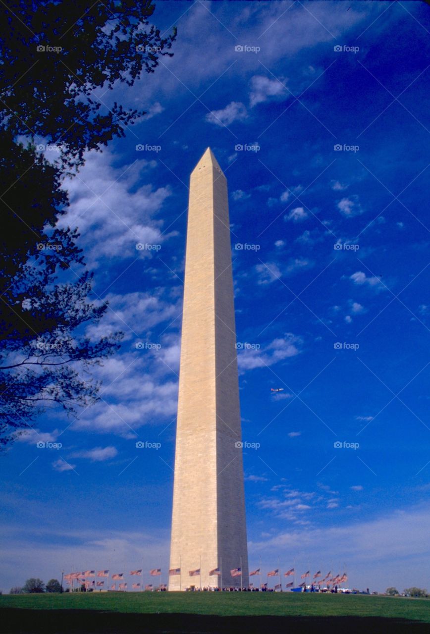 Washington Monument. Washington Monument with all flags showing against a deep blue sky