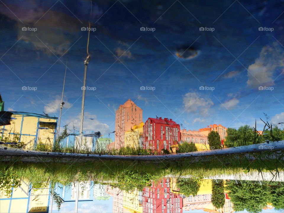 Mirror image of houses in a puddle, Kiev,