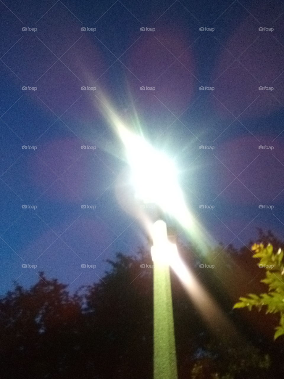 a close up streetlight against the night sky