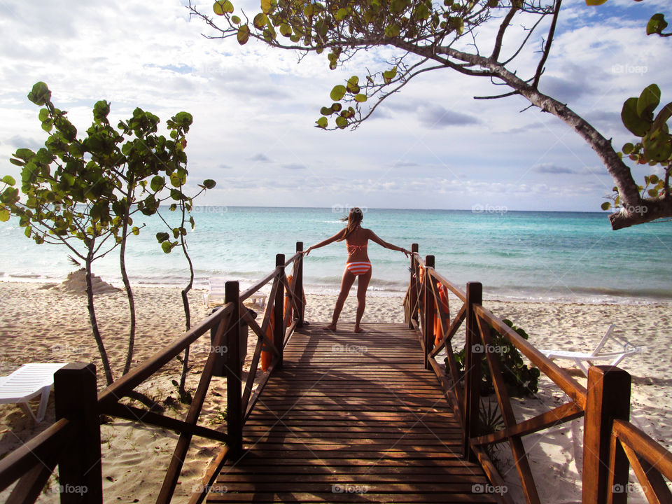 Woman in bikini looking over calm sea