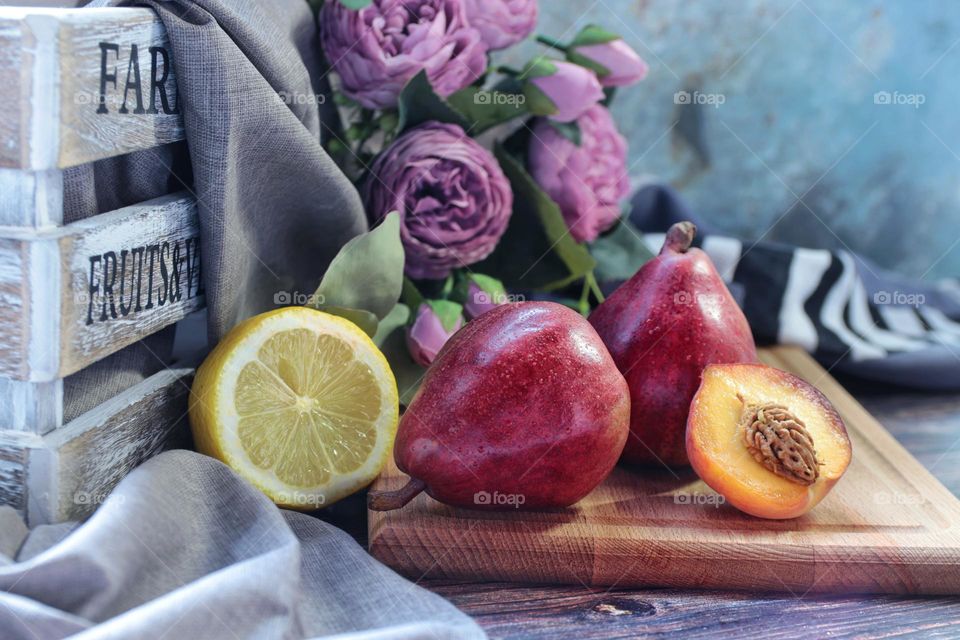 fruits lemon, pear and peach on the table