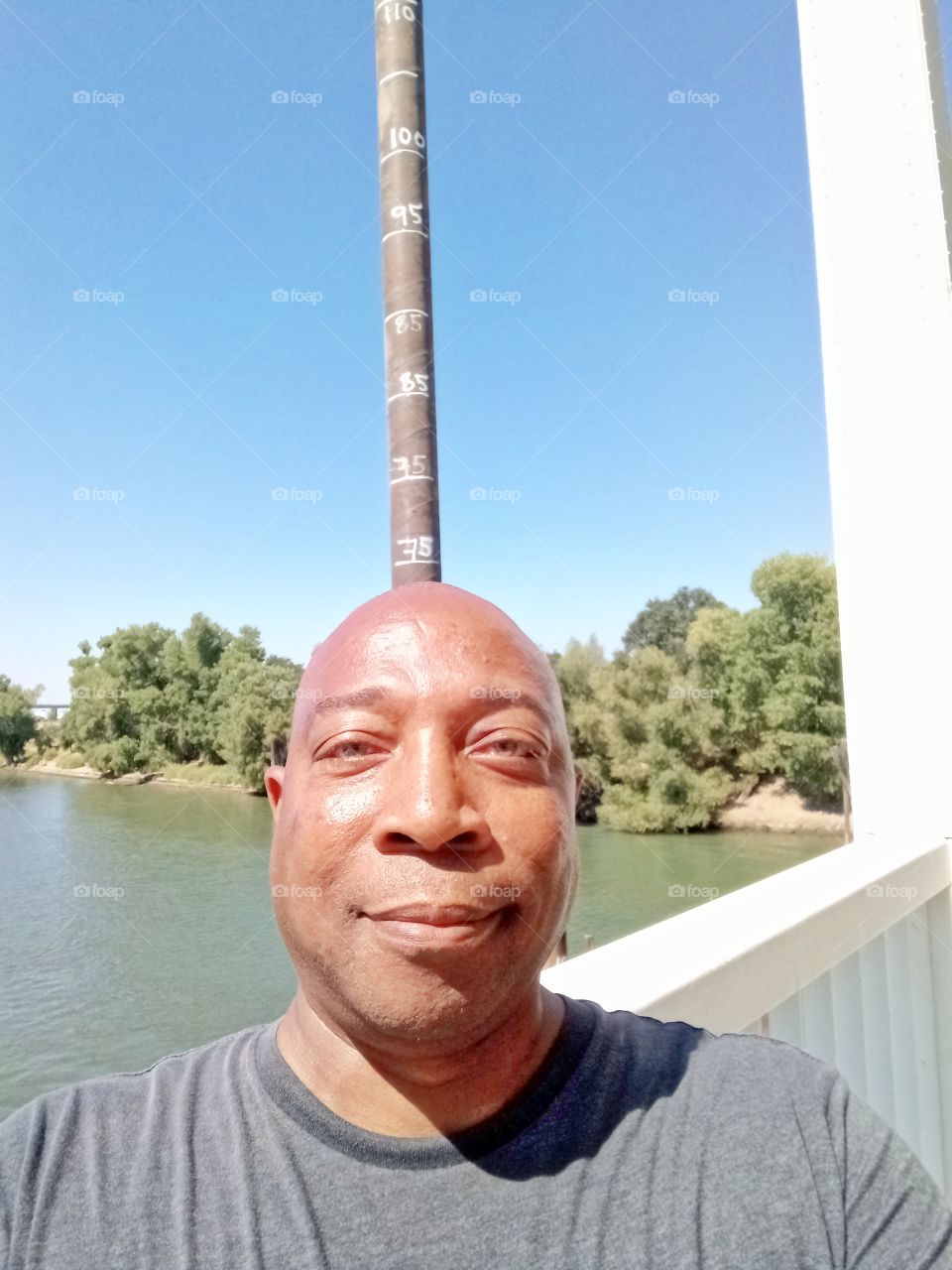 selfie, on a bridge overlooking the river taking a selfie pic in Sacramento California