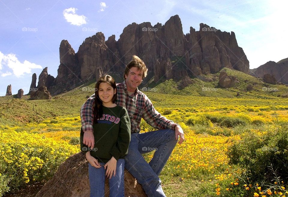 Father and daughter stop for a portrait while hiking in the