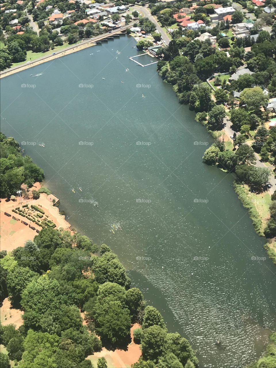 Aerial shot from a helicopter of lake in the city 