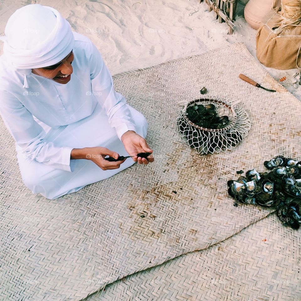 Young man in Dubai looking for pearls 