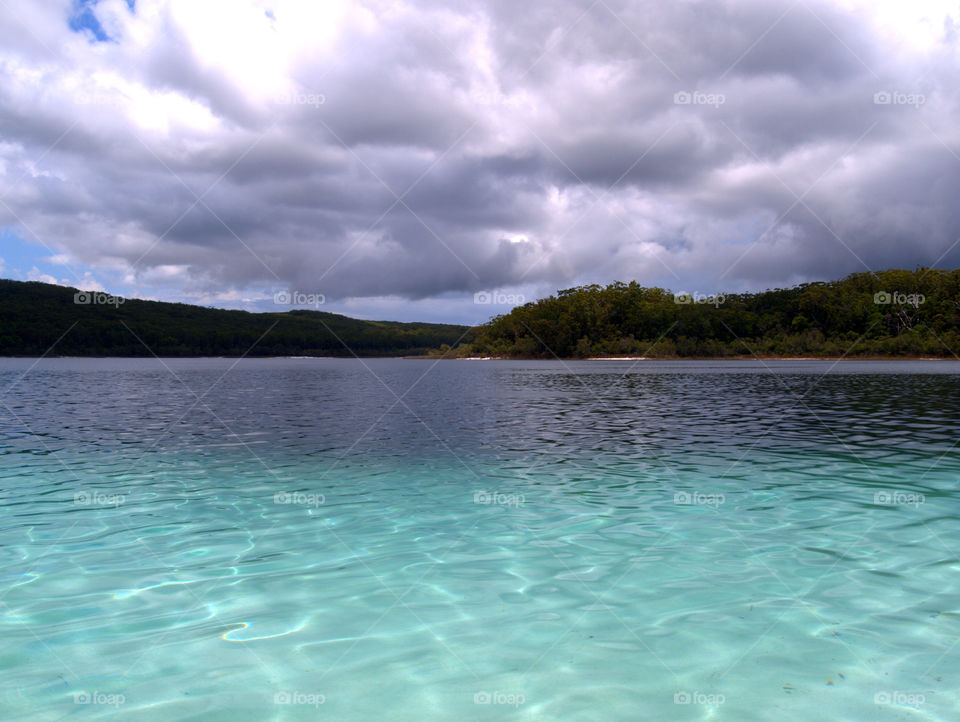 Stormy clouds over a clear lake