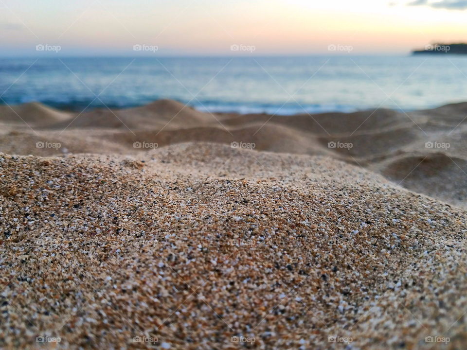 Close up on sand with a Molokai sunset