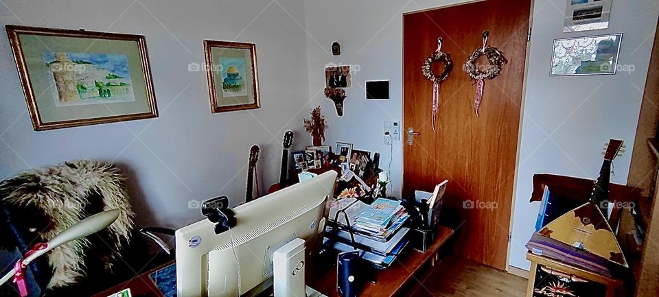 This is one of the rooms in the beautiful one story house in „Bavaria“, Germany. The computer monitor on the table indicates that it is being used to work and to study. 2023. Hypnotic Productions