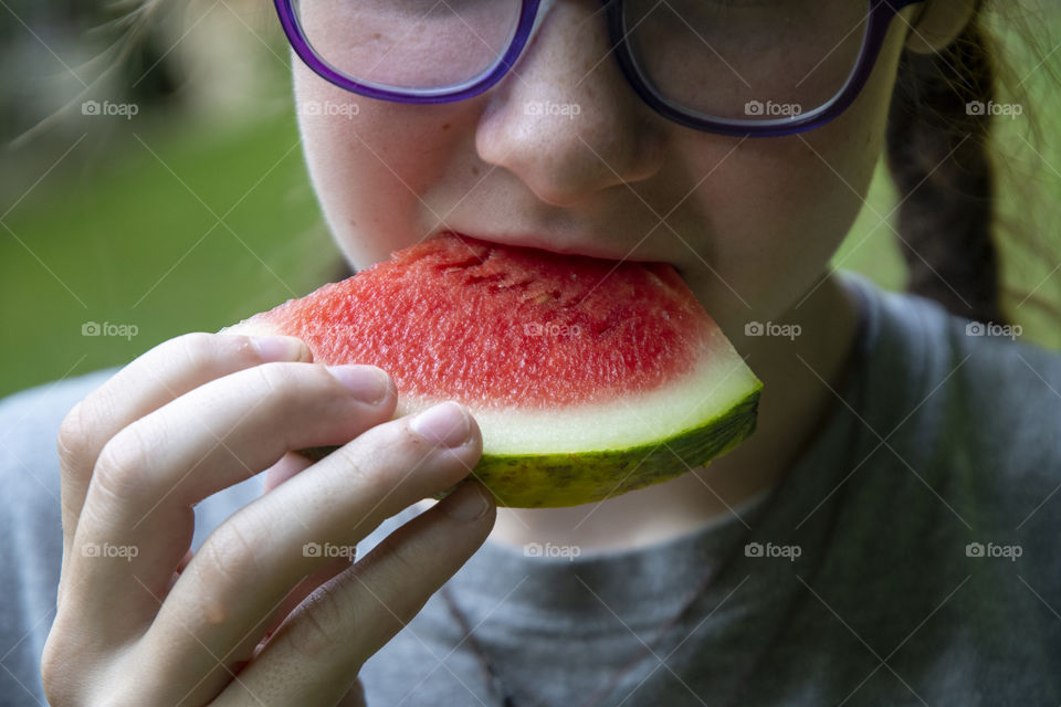 Girl eating fresh watermelon 
