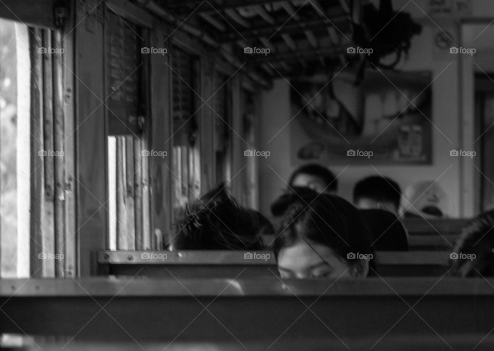 Beautiful eyes be-hide the bench on the train 