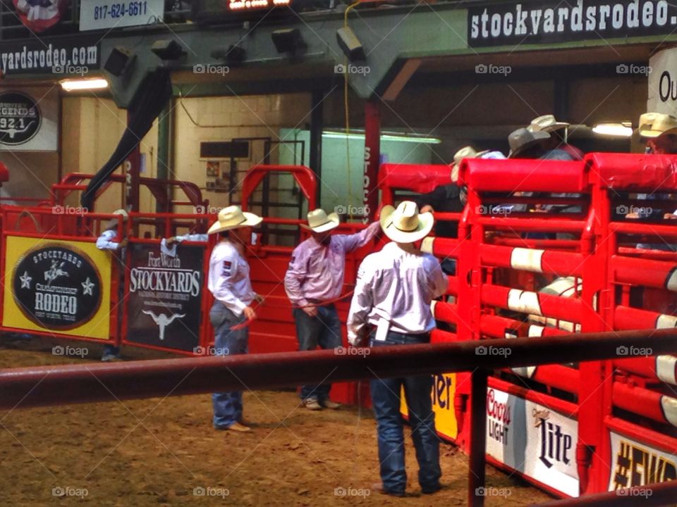 Cowboy break. Cowboys taking a break before releasing another bull rider