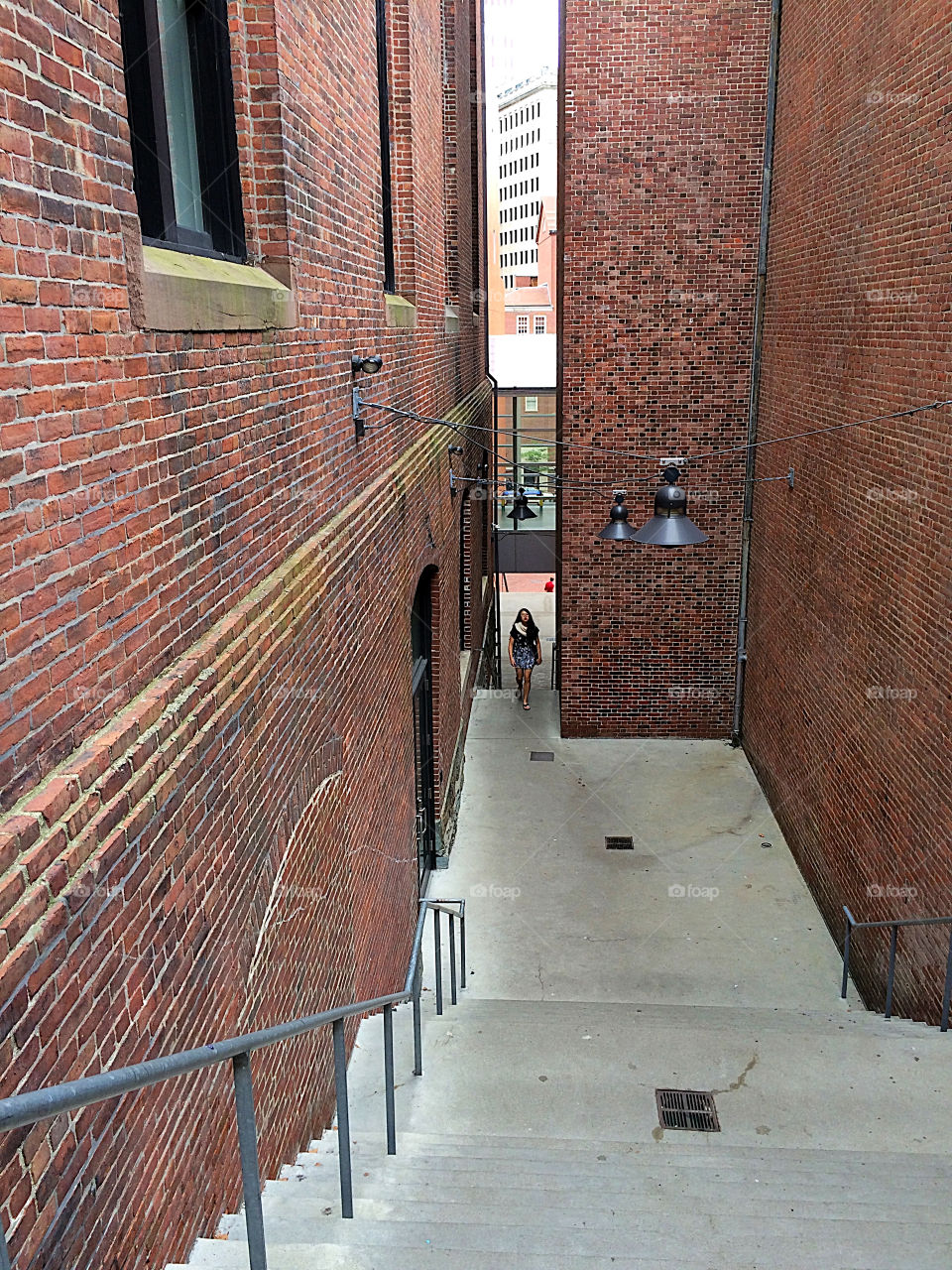 Walking up the stairs between two buildings in downtown 