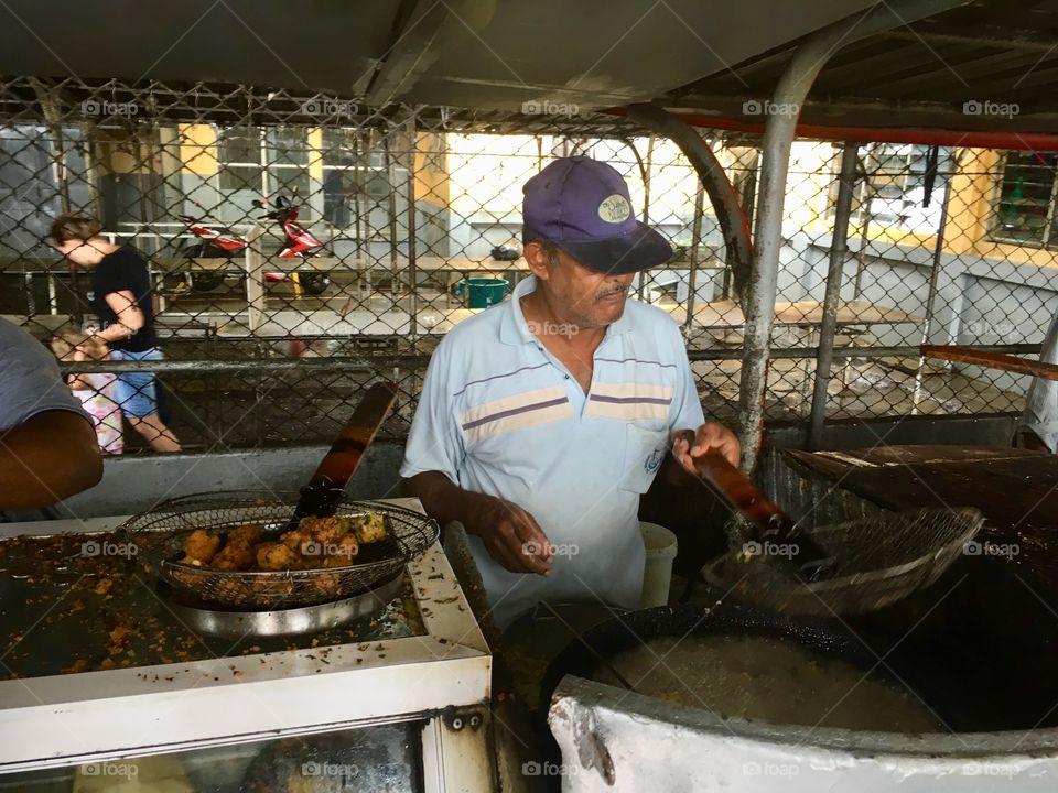 Man frying dhal puri