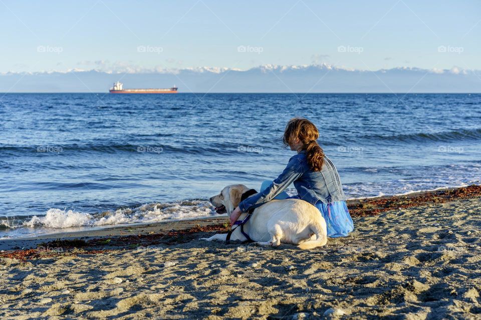 Girl and dog enjoy scenic beach 