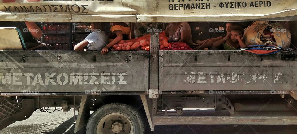 A family of Roma traveling inside a truck with their merchandise in Athens