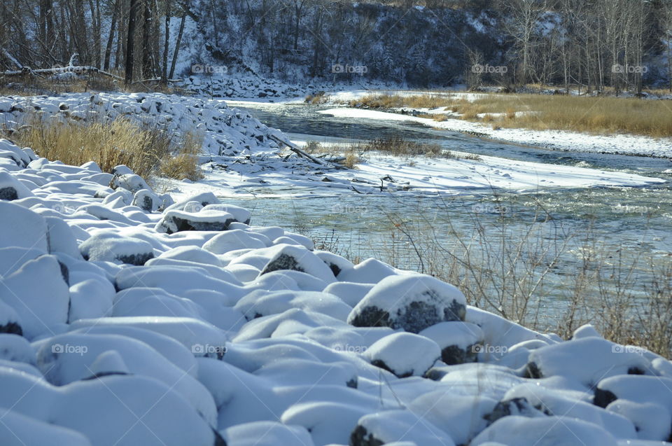 Snow covered stones by the river