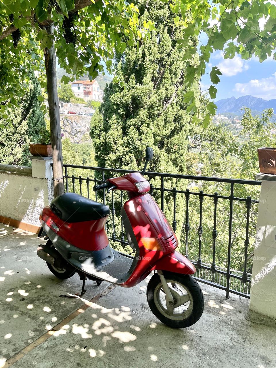 Red scooter in the Italian yard 