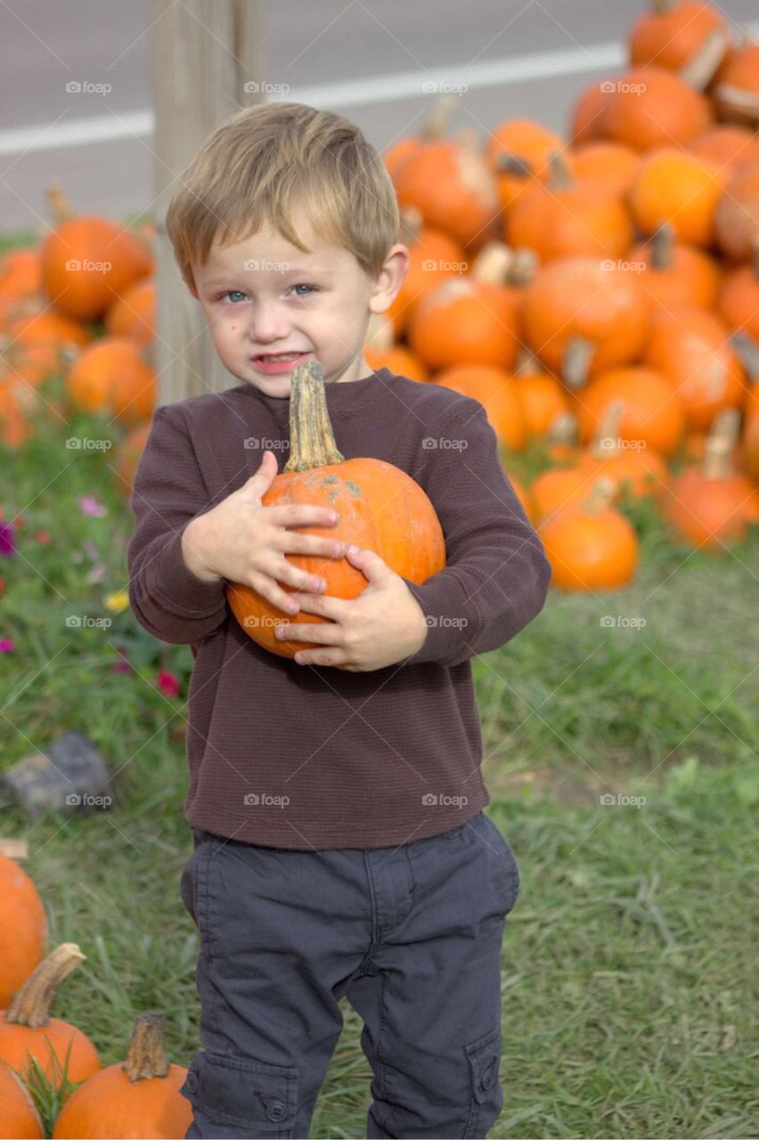 Close-up of a boy holding pumpkin