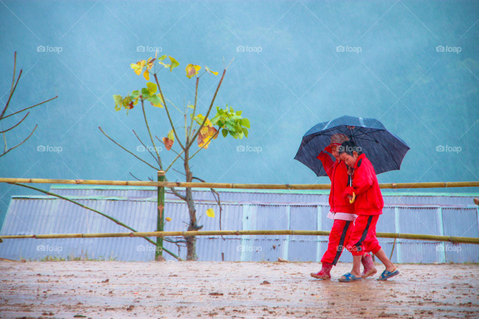 Children in red on a rainy day.