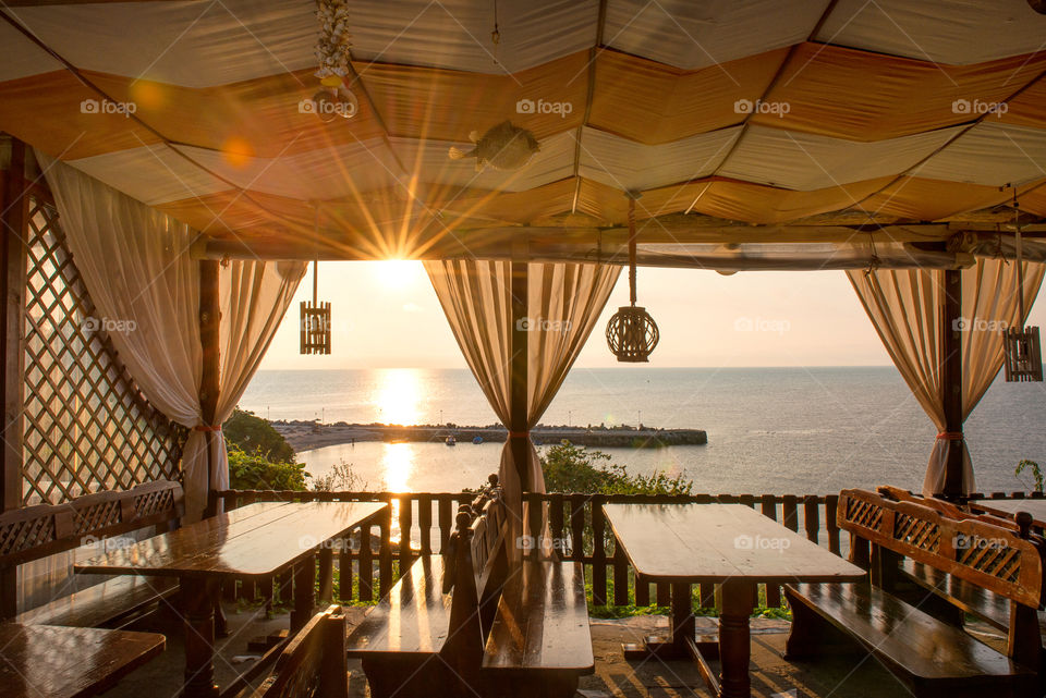 cozy cafe on the seaside in a sunrise hour