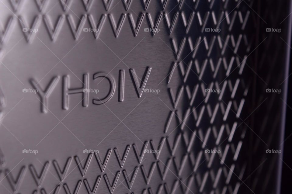 vichy logo engraved on metal box.